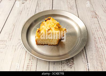 Lemon sponge cake with a refreshing citrus touch, made with natural lemon zest and topped with a lemon meringue glaze Stock Photo