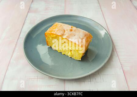 Vanilla and raspberry sponge cake with alternating layers of raspberry cream, decorated with fresh raspberries and melted white chocolate Stock Photo