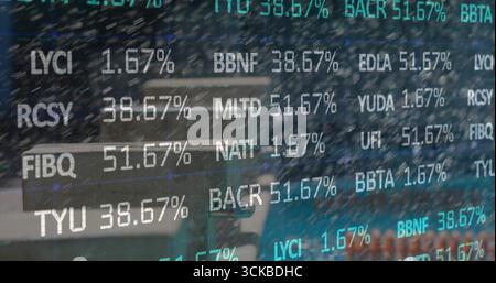 Displaying ticker symbols with percentages over round cafe table, metal chairs and laptop computer. Technology, innovation, modern, business, analytic Stock Photo