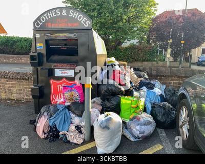 Slough, Berkshire, UK. 5th September, 2025. Clothes illegally fly tipped in a Tesco Express car park in Slough, Berkshire next to a Salvation Army clothes and shoes donation bank. Credit: Maureen McLean/Alamy Stock Photo