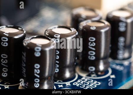 Group of capacitors close up on computer motherboard, hardware components Stock Photo