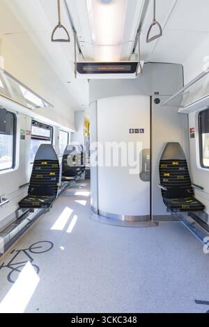 Modern and clean interior of a train with blue rows of seats and lots of light, battery Electric train with green electricity, Siemens Mireo Plus B, F Stock Photo