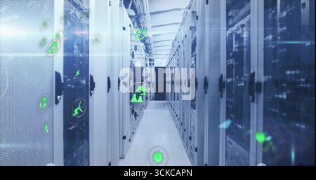 Showing server racks lining narrow data center corridor, projecting holographic green energy icons. Technology, networking, industrial, futuristic, su Stock Photo