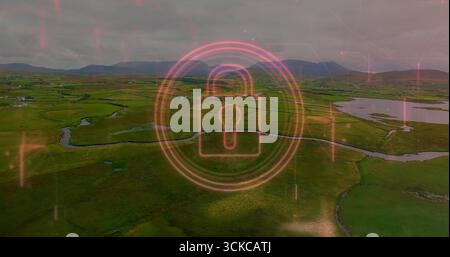 Hovering neon pink digital padlock icon showing security interface over rural fields with waterways. Aerial, landscape, digital, security, technology, Stock Photo