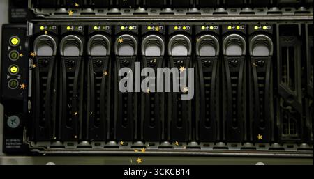 Server storage array displaying drive caddies with LED lights in data center rack, with empty bay. Technology, data, infrastructure, cybersecurity, di Stock Photo