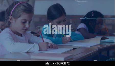 Writing three students working at wooden desk in classroom, using colored pencils and notebooks. Education, childhood, learning, creativity, collabora Stock Photo