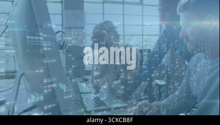 Collaborating developers discussing code on laptop, monitor in modern office, with data overlay. Collaboration, teamwork, technology, innovation, mode Stock Photo