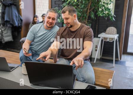 Happy start up team talking while having a break during working hours in modern office. Stock Photo