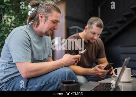 Casual Meeting in Modern Cafe. Team of programmers writing digital code in the metaverse and working together Stock Photo