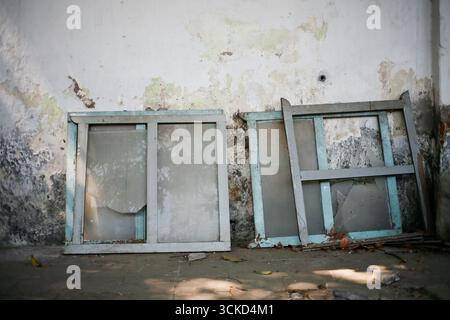 broken window frame leaning on he wall Stock Photo