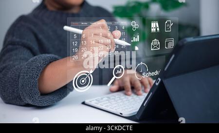 Person using digital calendar and task management interface, symbolizing business planning, scheduling, productivity, and efficient workflow managemen Stock Photo