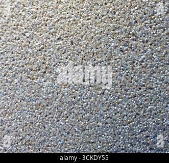 Close-up textured surface of small pebbles on a beach Stock Photo