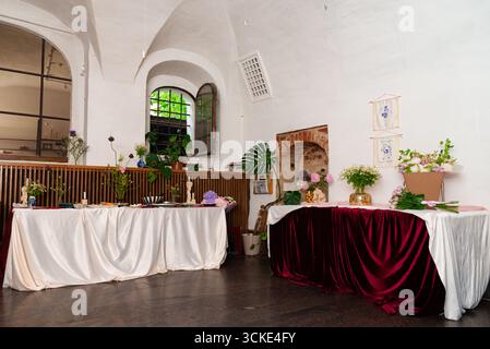 Elegant reception room with decorated tables and floral arrangements. Stock Photo