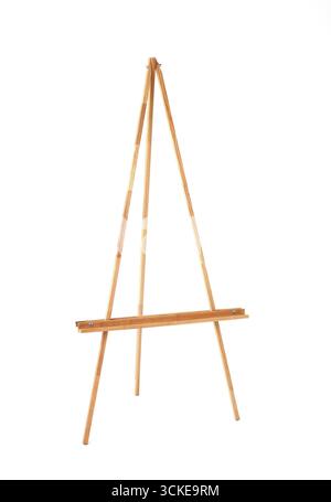 Empty wooden artist's easel, standing tall and ready, isolated on a bright white background.  Stock Photo