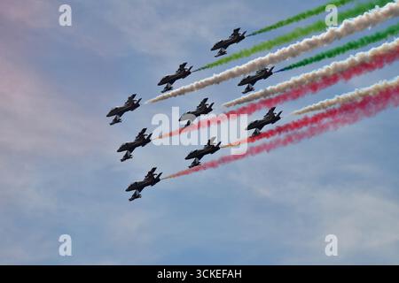 The Frecce Tricolori air display team trailing green, white and red smoke as they perform in the sky above the Monza motor racing circuit in Italy. Stock Photo