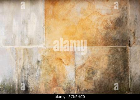 warm‑toned plaster surface with multiple panel seams, natural discoloration, and subtle hand‑trowel marks. Versatile background, overlay, or 3D materi Stock Photo