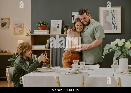 Caucasian Middle Aged Couple Smiling While Teenager Boy Taking Photograph Stock Photo