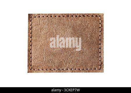 Brown leather patch with stitching detail. Blank rectangular label closeup. Fashion design accessory element. Textile decoration for clothes branding. Stock Photo