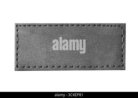 Blac leather label isolated on white. Textile patch rectangle with stitching detail. Fashion accessory closeup. Material design element. Stock Photo