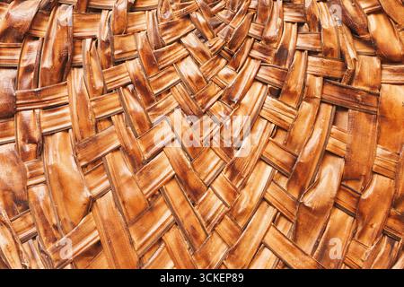 Wicker basket texture closeup. Brown natural woven surface background. Rustic handicraft detail. Organic material design element. Decorative artisan. Stock Photo