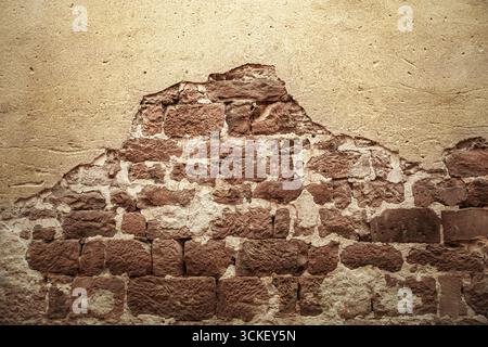 Red stone wall and partly plastered Stock Photo
