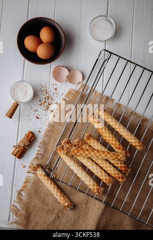 Traditional homemade waffle rolls with ingredients on rustic kitchen background Stock Photo