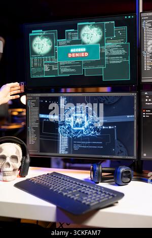 Hacker covering mouth in disbelief, seeing access denied warning on computer when hacking firewalls. Evil man shocked after failing to break into enterprise database, getting cyber attacks rejected Stock Photo