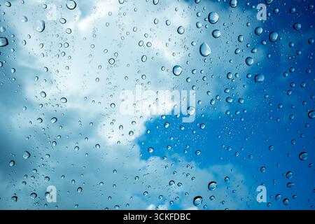 Water droplets on glass with storm clouds in the sky above Stock Photo