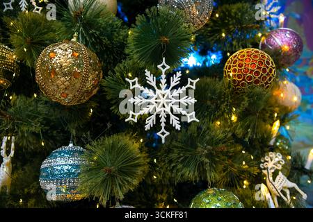 Image Christmas tree toy snowflake in multi-colored Balls on branches of artificial spruce Stock Photo