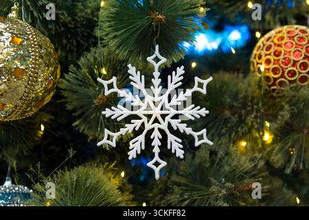 Image Christmas tree toy snowflake in multi-colored Balls on branches of artificial spruce Stock Photo