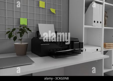Modern printer on desk in office, closeup Stock Photo