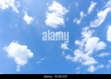 Low angle view and full frame of beautiful blue sky with strange shape of fluffy white clouds in the afternoon on sunny day Stock Photo