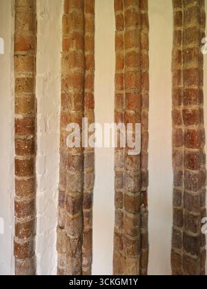 An old wall corner with rounded, molded bricks in the cathedral in Ratzeburg. An expression of historic architecture. Copyspace Stock Photo