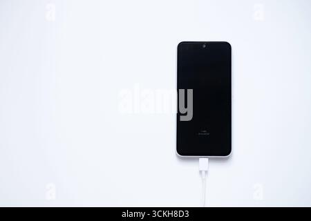 Charging mobile phone battery, isolated on white background Stock Photo
