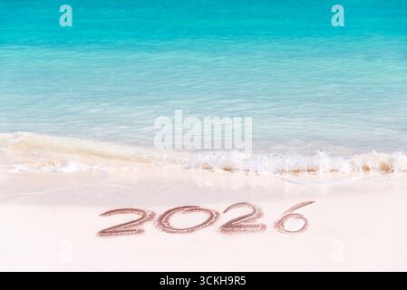2026 written on the sand of a tropical beach, travel new year holiday card Stock Photo