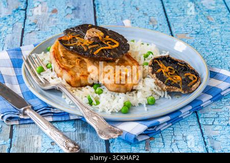 Orange glazed pork escalopes and portobello mushrooms with rice Stock Photo