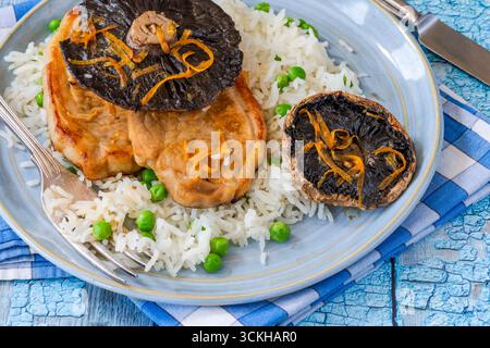 Orange glazed pork escalopes and portobello mushrooms with rice Stock Photo