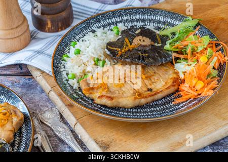 Orange glazed pork escalopes and portobello mushrooms with rice Stock Photo