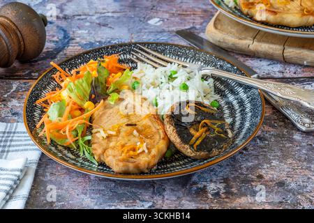 Orange glazed pork escalopes and portobello mushrooms with rice Stock Photo