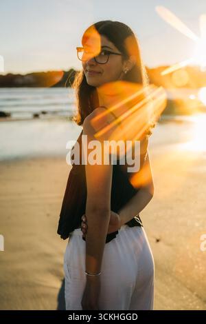 Woman nature sunlight enjoying the golden hour while smelling spring ...