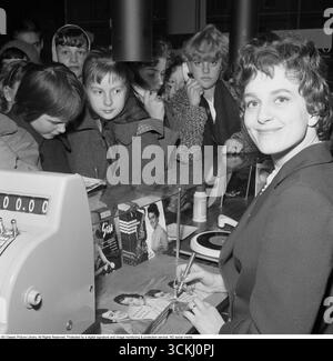 Siw Malmkvist, Swedish artist and singer born 1936. Pictured in a record store signing her album with the song Augustin. She won the swedish Melodifestivalen with the song but was considered too young to perform it in the international Eurovision contest. The song became a huge hit in Sweden.  Siw Malmkvist has recorded around 600 songs in ten different languages (Swedish, English, Finnish, Norwegian, Danish, German, Dutch, French, Italian and Spanish) and has had 40 songs on Svensktoppen until 2012. Among her many hits are: “Jazzbacillen”, “Flickor bak i bilen”, “Skona mitt hjärta”, “Slit och Stock Photo