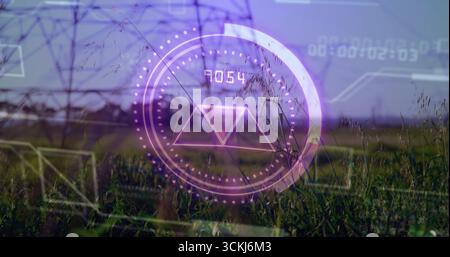 Displaying purple HUD overlaying grassland with pylons, round gauge, triangle and numeric readout Stock Photo