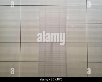 Shiny tiled wall surface with grid lines and faint reflection . High quality photo Stock Photo