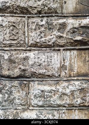 Close up of old stone brick wall with weathered rough texture . High quality photo Stock Photo