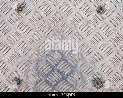 Close up of metal diamond plate texture with raised pattern for grip . High quality photo Stock Photo
