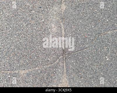 Close up of cracked asphalt pavement surface with rough texture . High quality photo Stock Photo