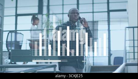 Man descending office stairway talking on smartphone, with tablet, bar chart overlay Stock Photo