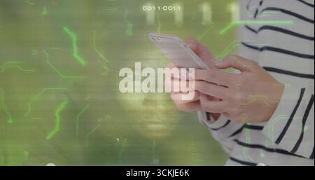 Gripping smartphone, woman in striped shirt scanning screen against circuitry backdrop, copy space Stock Photo