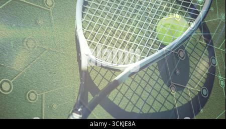 Displaying white tennis racket lying on green court, with yellow tennis ball, circuit overlay Stock Photo
