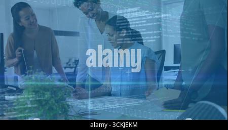 Collaborating women analyzing documents on laptop at office desk, with code and graph overlay Stock Photo